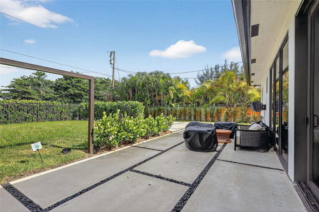 11405 East Golf Drive Miami, FL 33167 - Photo 7 of 25 a view of a patio with couches plants and city view