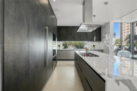 a living room with stainless steel appliances kitchen island granite countertop furniture and a kitchen view