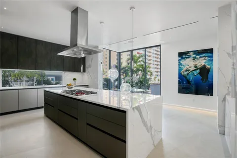 a kitchen with stainless steel appliances a sink and cabinets