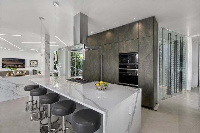 a dining hall with couches a flat tv screen and couches with wooden floor