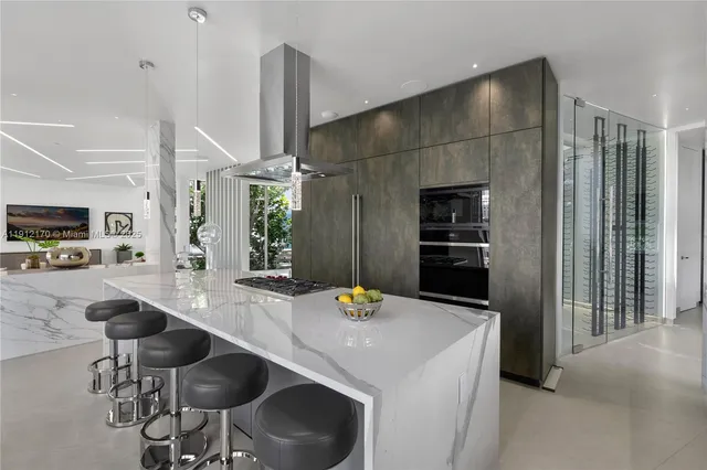 a dining hall with couches a flat tv screen and couches with wooden floor