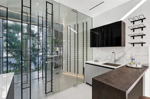 a living room with furniture kitchen view and a large window