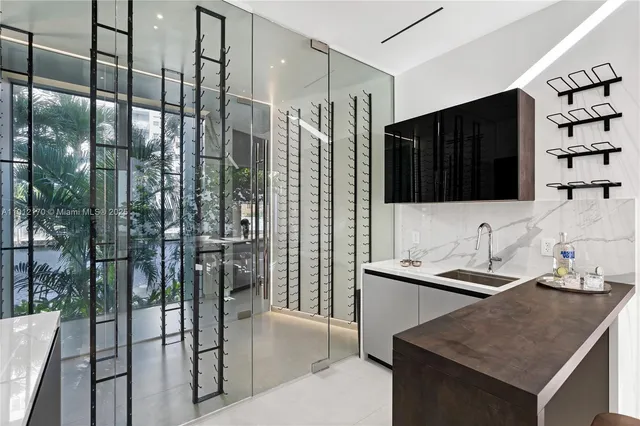 a living room with furniture kitchen view and a large window