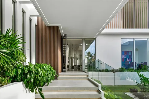a hallway with a view of living room with furniture