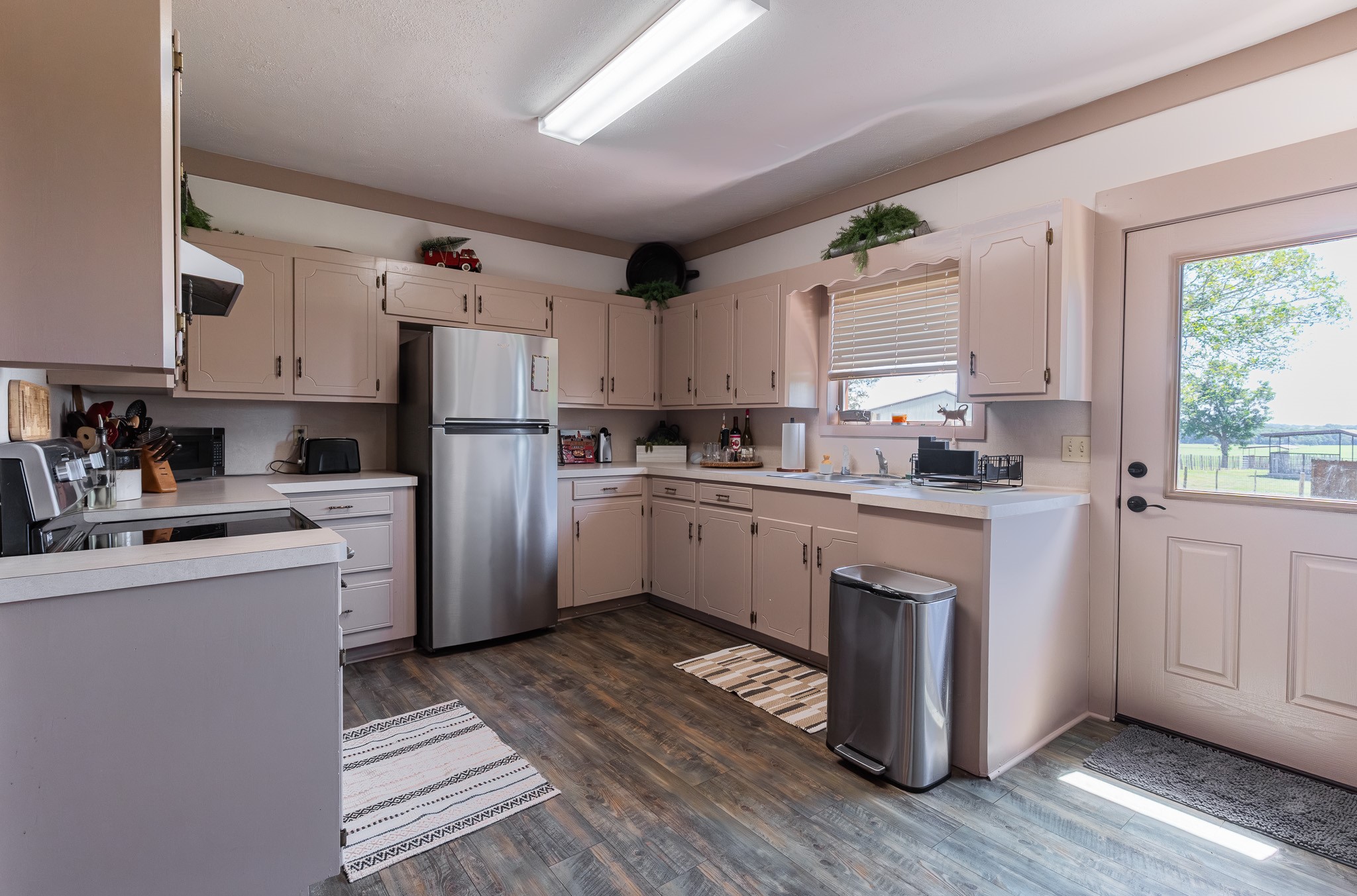 1119 Wolters Road Schulenburg, TX 78956 - Photo 43 of 50 a kitchen with white cabinets sink and refrigerator