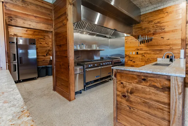 a view of a patio with table and chairs with wooden floor and fence