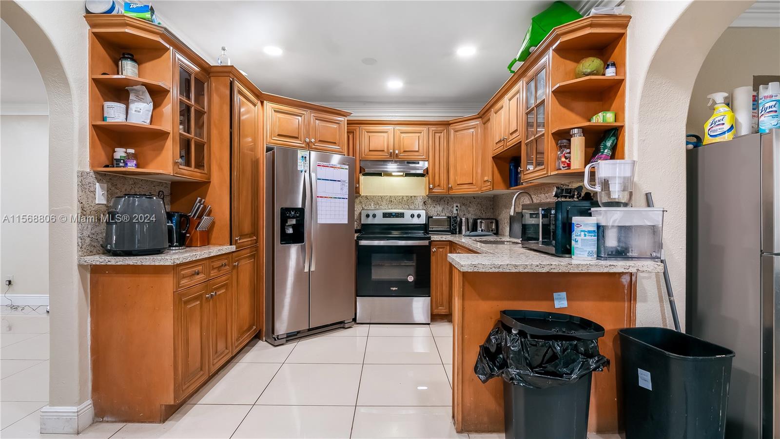 a kitchen with stainless steel appliances granite countertop a refrigerator and a sink