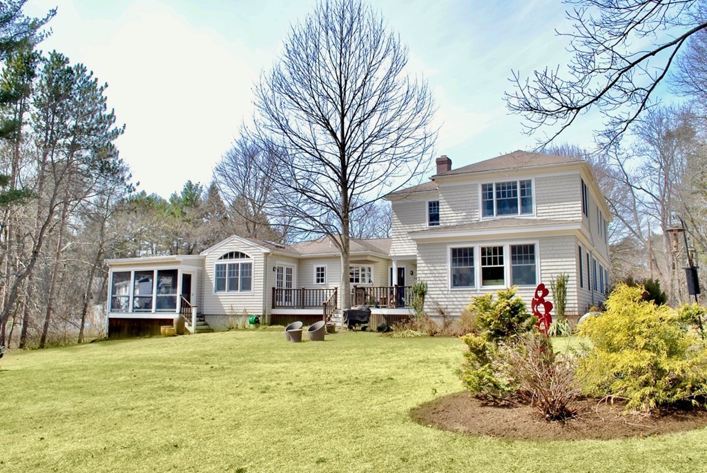 17 Giles Road Lincoln, MA 01773 - Photo 1 of 18 a front view of a house with a yard table and chairs