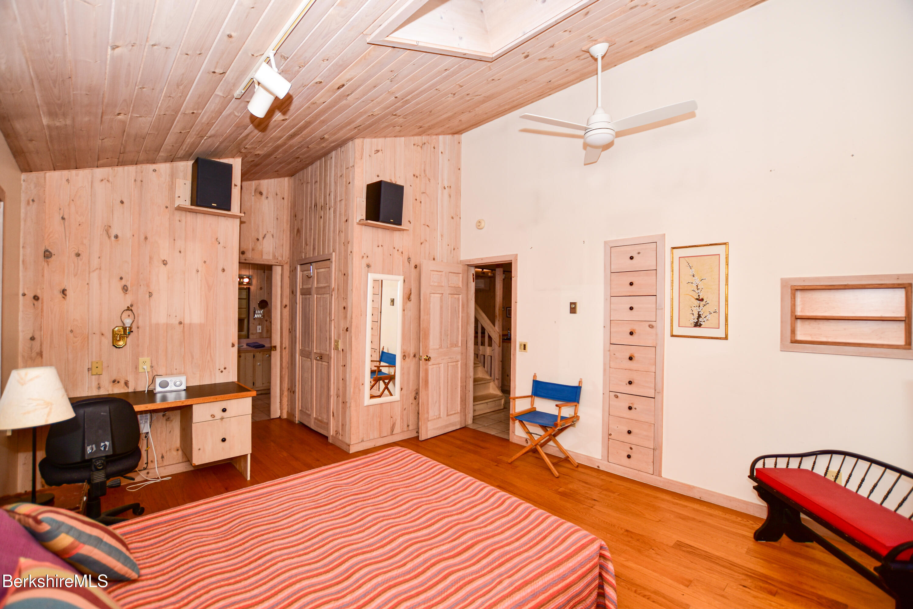 283 Benton Hill Road Becket, MA 01223 - Photo 16 of 55 a bedroom with a bed and a chandelier