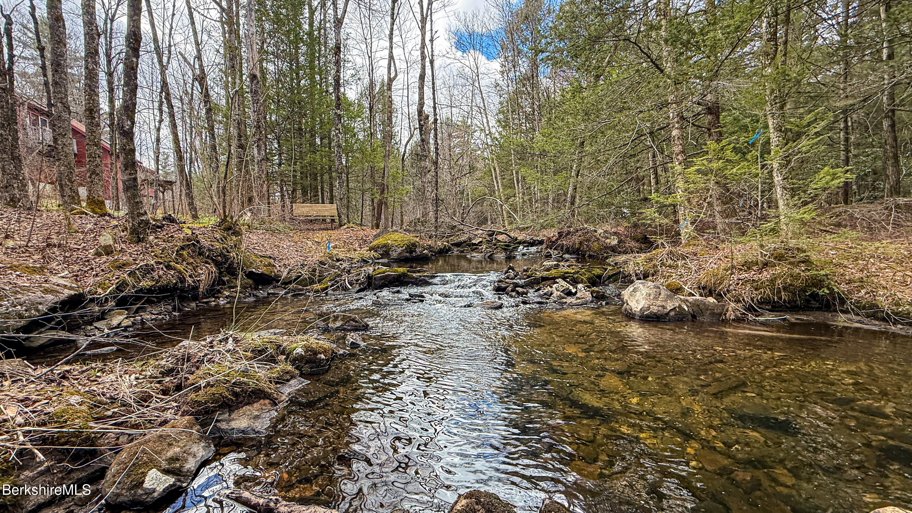 283 Benton Hill Road Becket, MA 01223 - Photo 2 of 55 a view of a lake with lots of trees