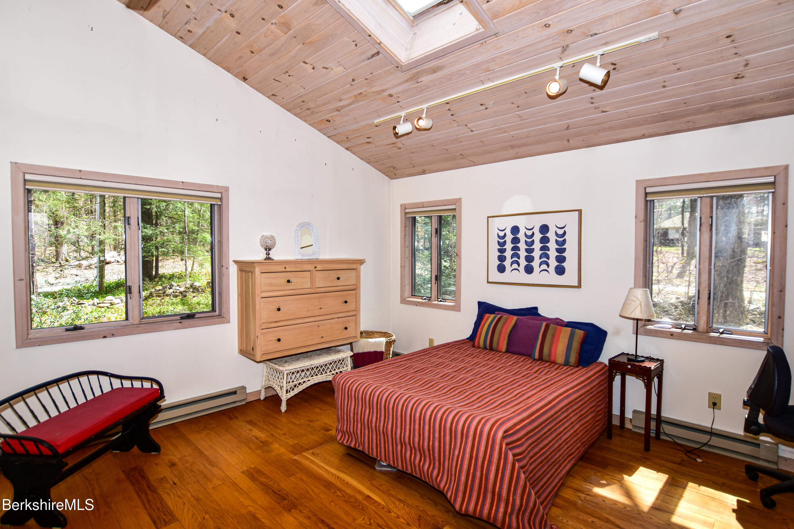 283 Benton Hill Road Becket, MA 01223 - Photo 21 of 55 a bedroom with a bed and wooden floor