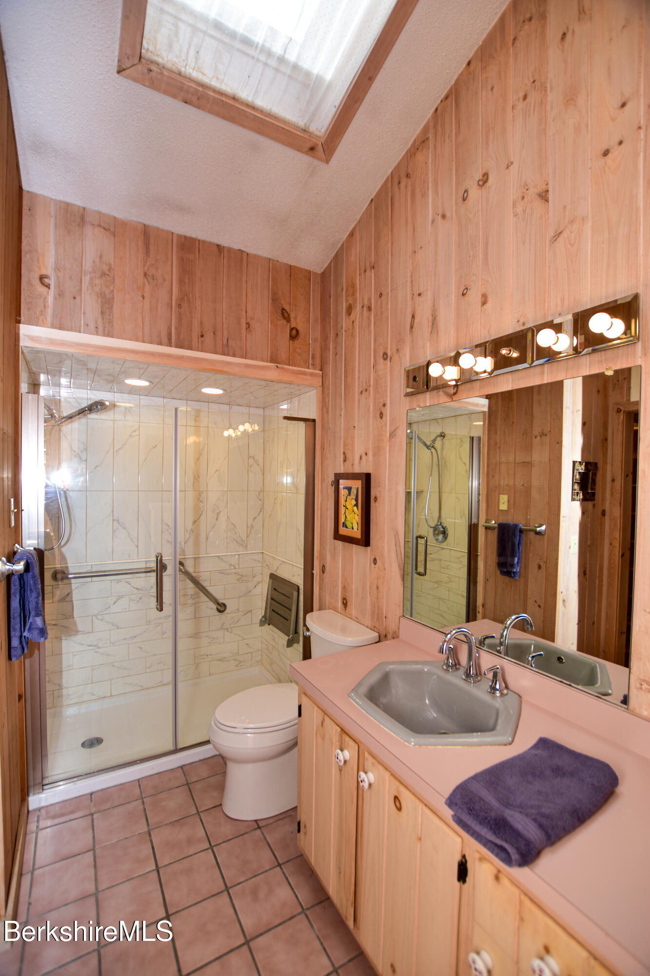 283 Benton Hill Road Becket, MA 01223 - Photo 23 of 55 a bathroom with a granite countertop sink a toilet a mirror and shower