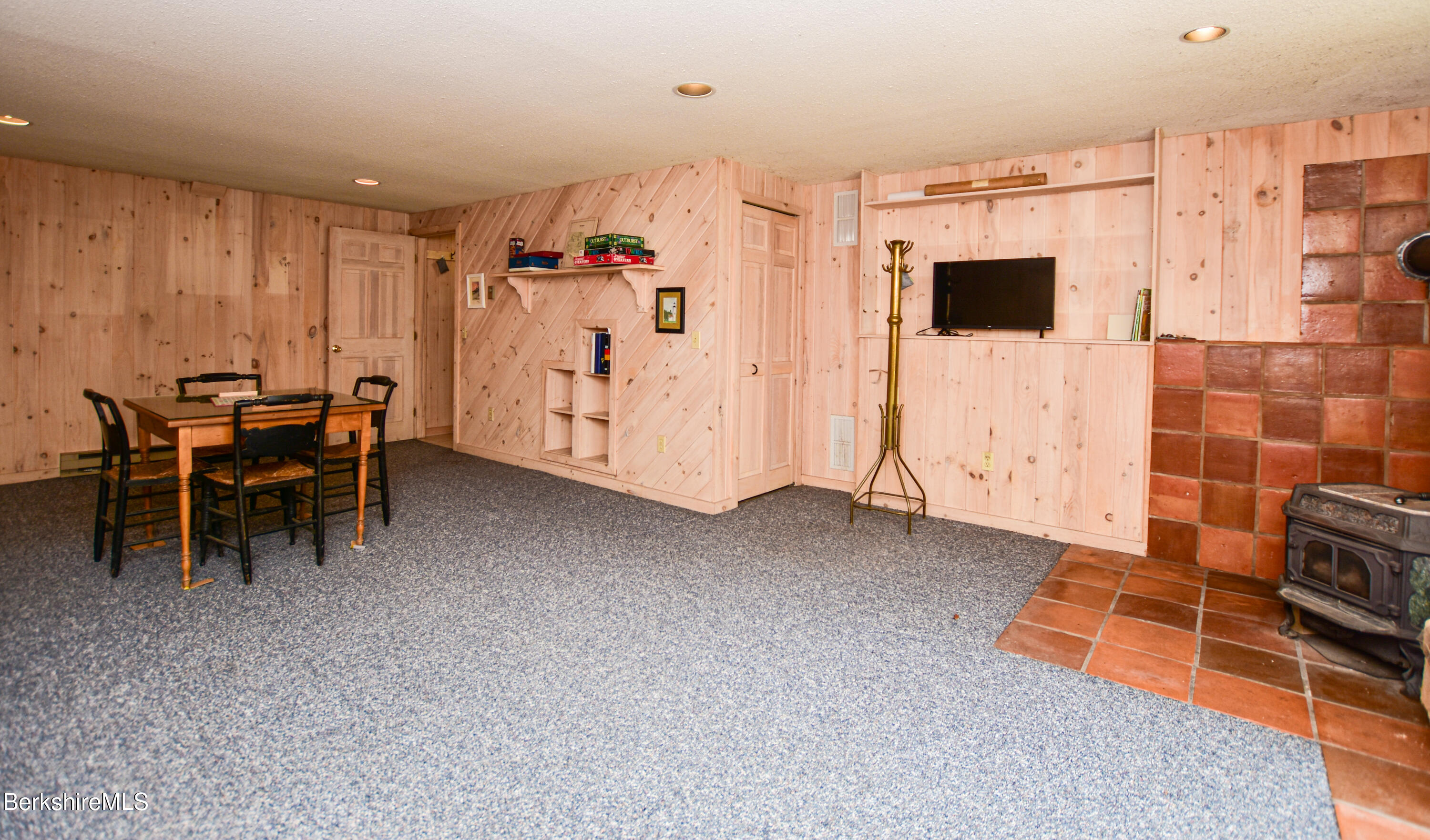283 Benton Hill Road Becket, MA 01223 - Photo 39 of 55 a living room with furniture and a flat screen tv