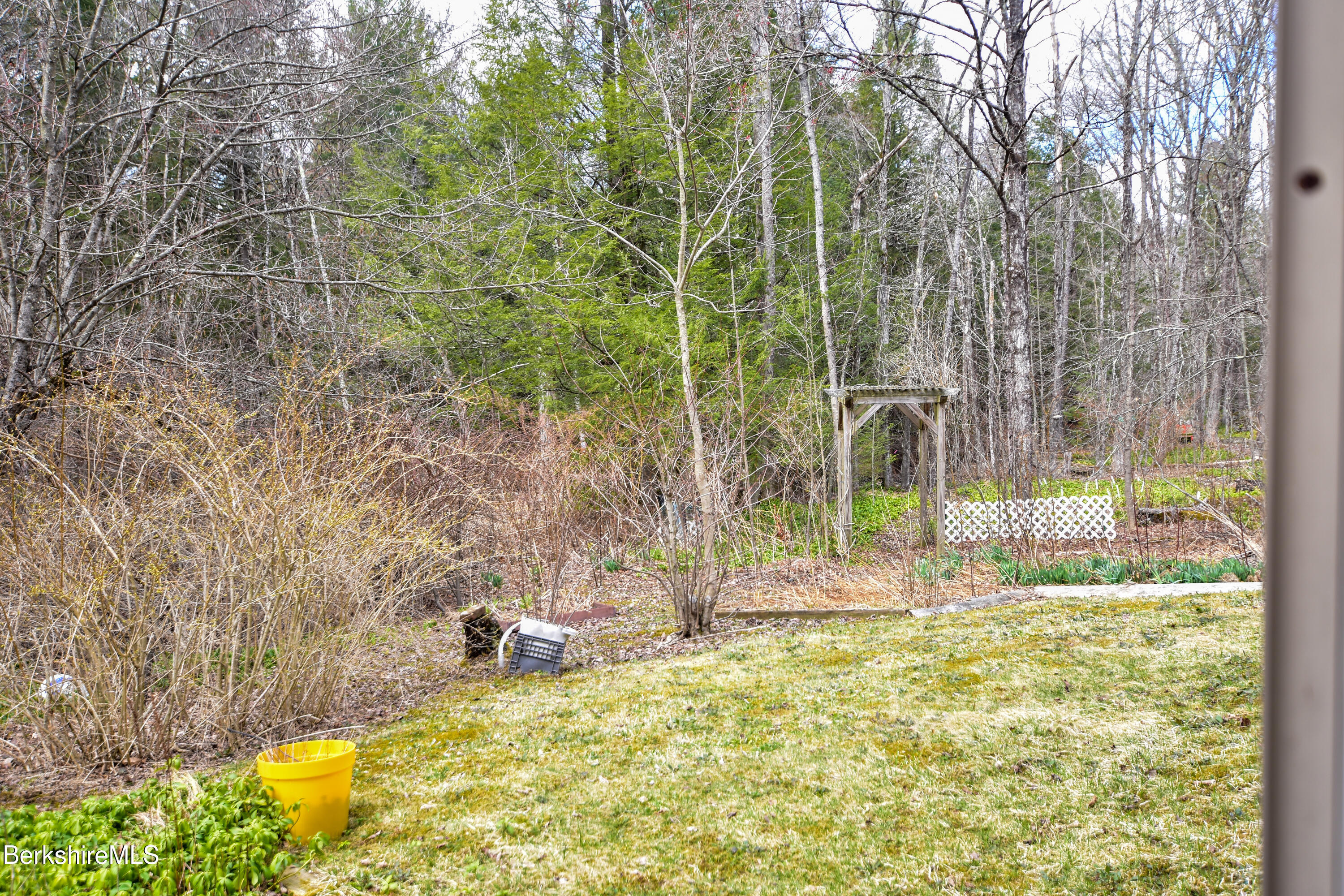 283 Benton Hill Road Becket, MA 01223 - Photo 40 of 55 a view of a backyard with plants and large trees
