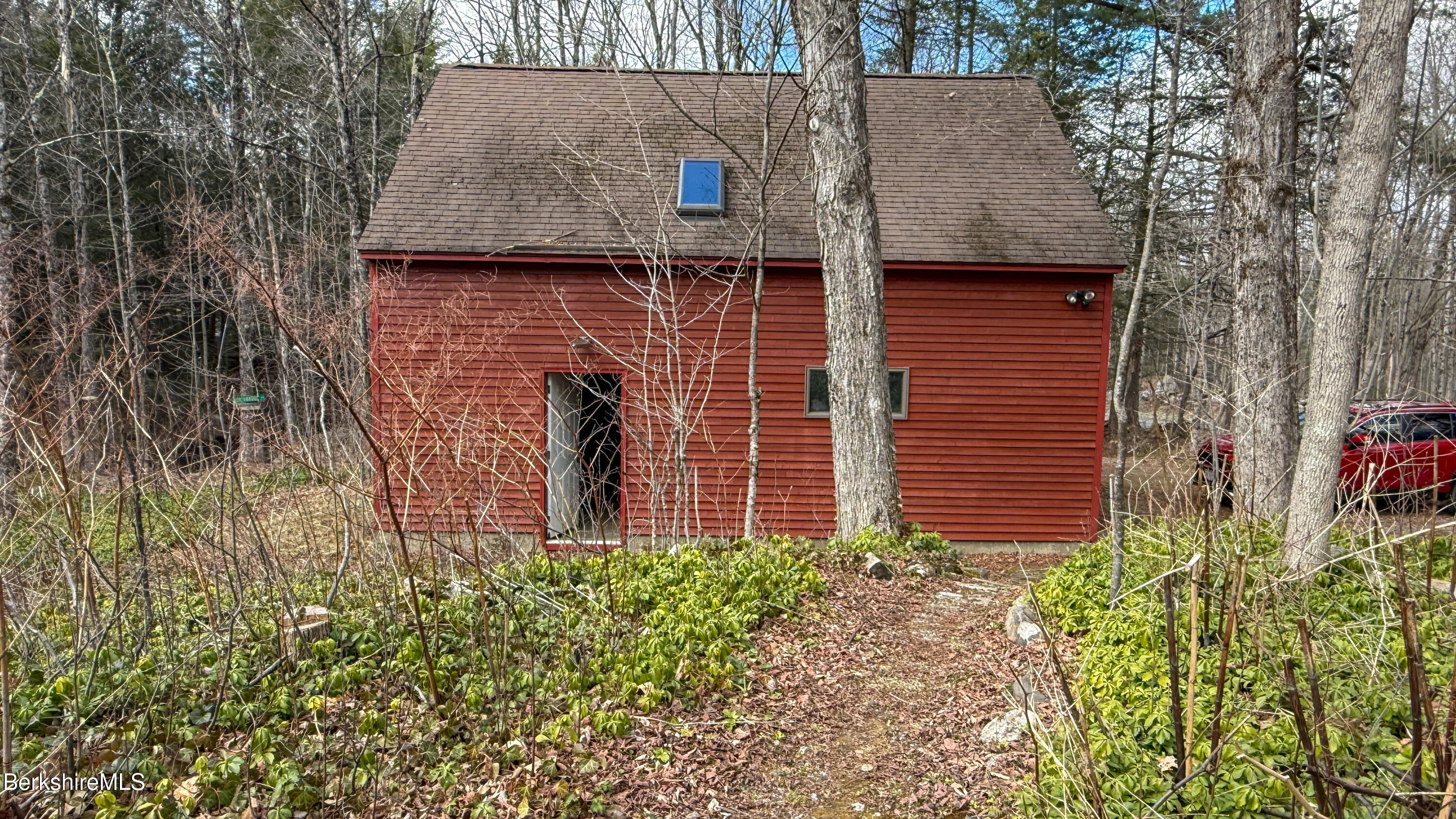 283 Benton Hill Road Becket, MA 01223 - Photo 45 of 55 a brick house with lots of green space