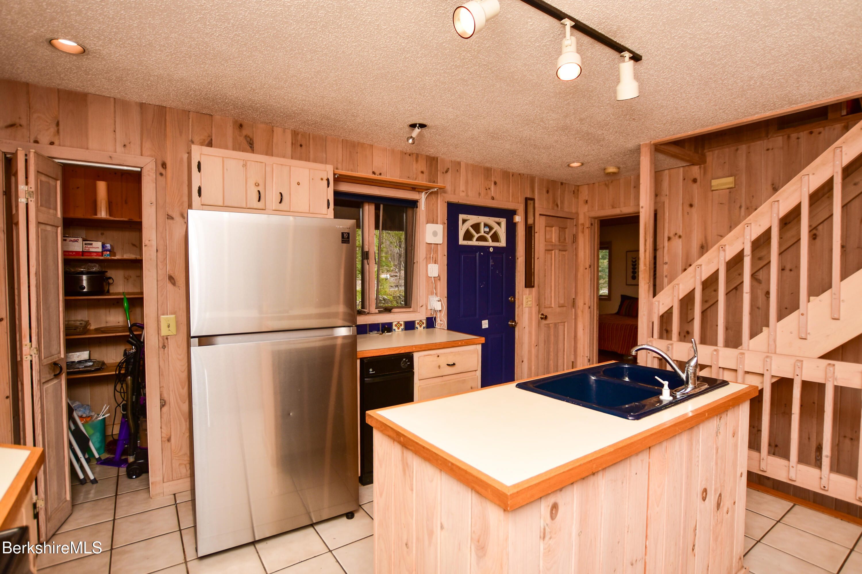 283 Benton Hill Road Becket, MA 01223 - Photo 8 of 55 a kitchen with stainless steel appliances a refrigerator sink and cabinets