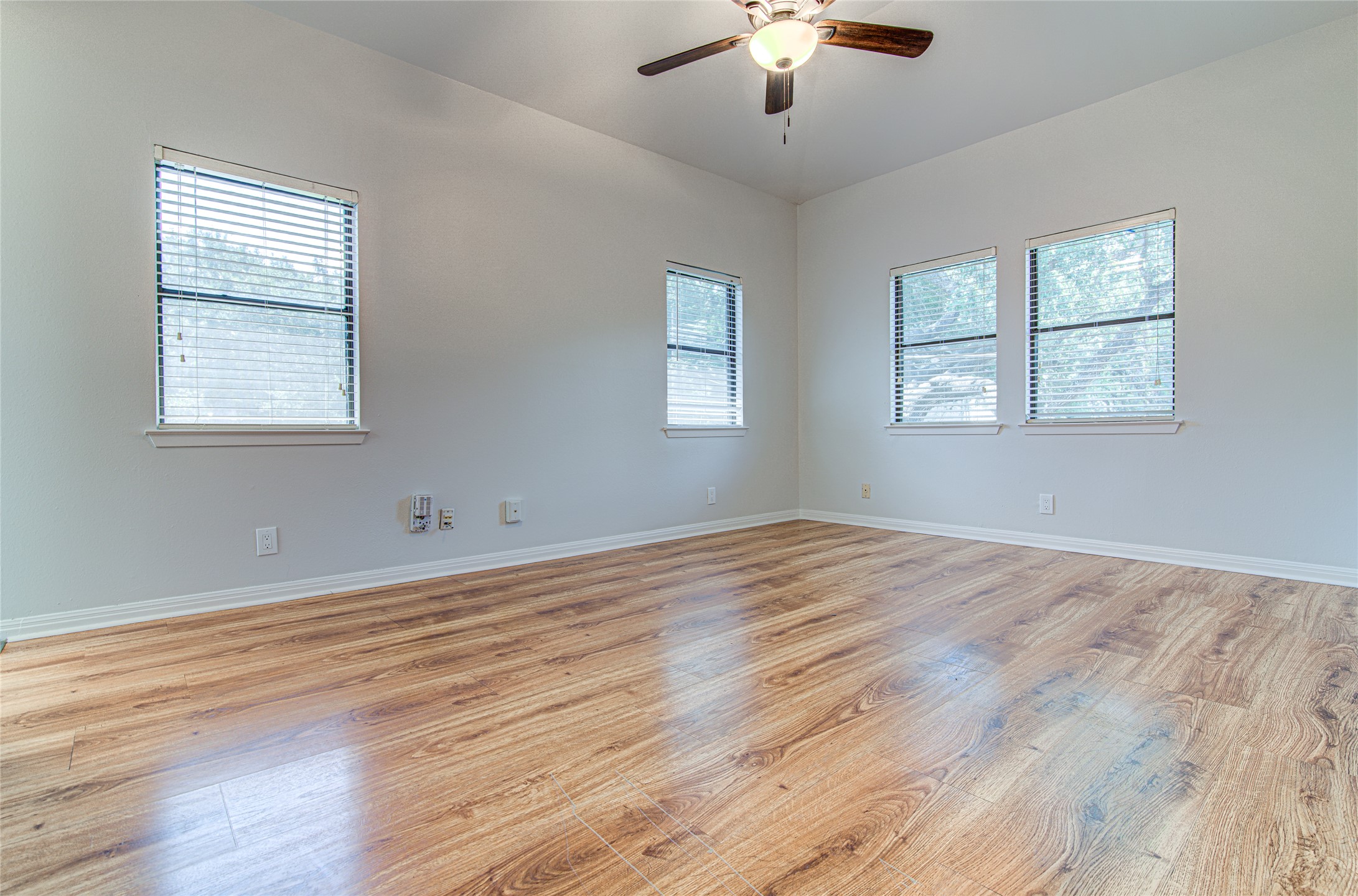 311 West Mary Street Austin, TX 78704 - Photo 7 of 35 A well-lit interior space with rich wood flooring and a classic ceiling fan awaits your personal touch.