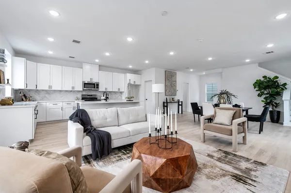 a living room with furniture and kitchen view