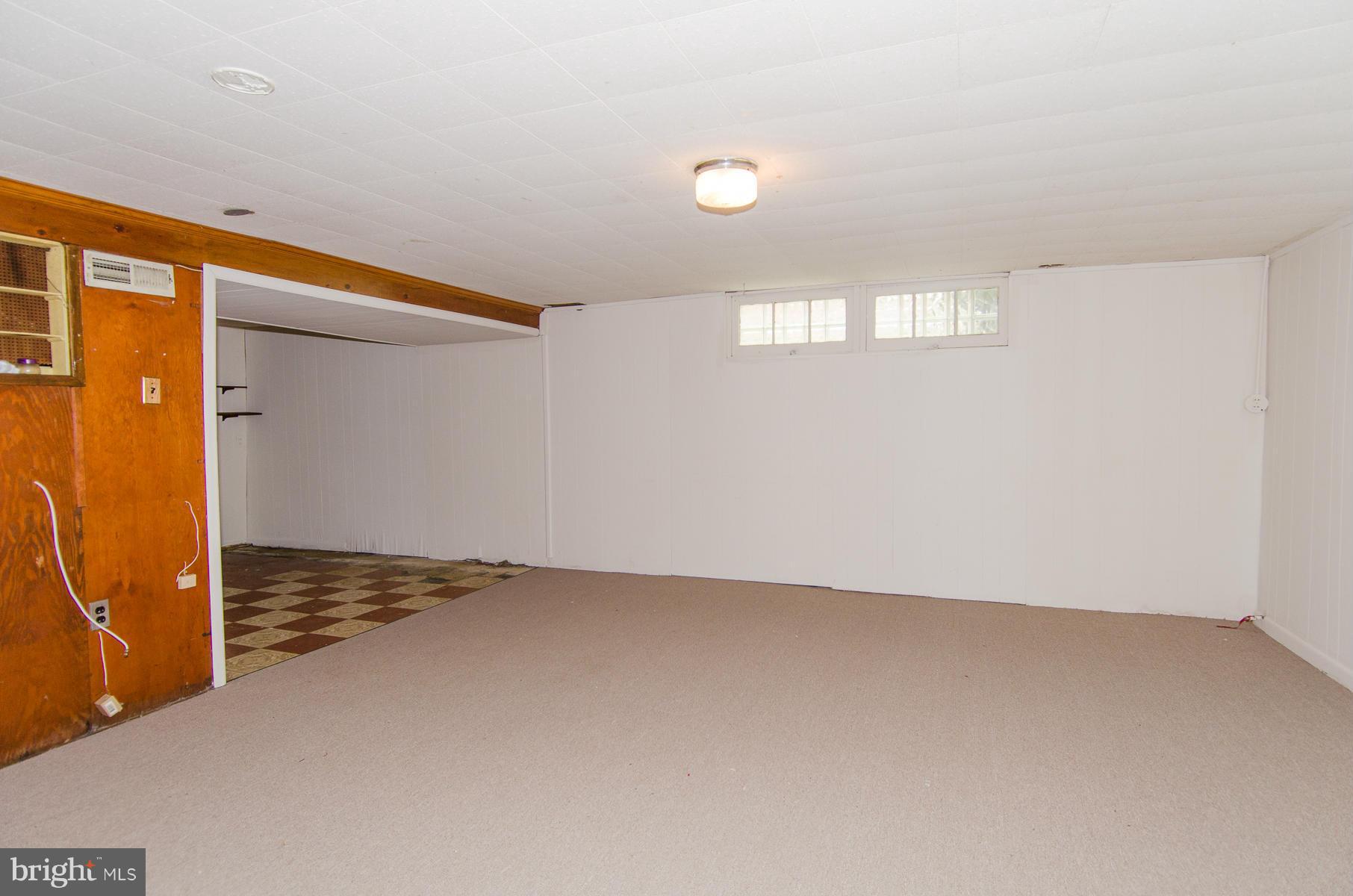 1417 Stonewood Road Baltimore, MD 21239 - Photo 18 of 28 an empty room with windows