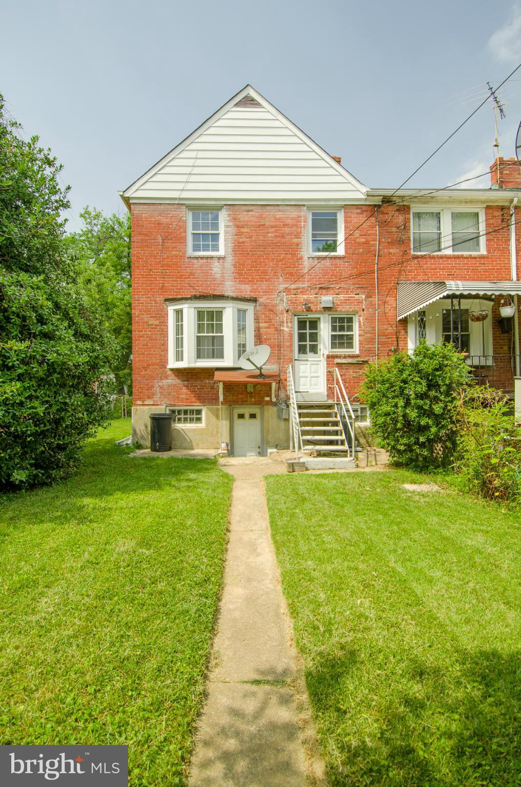 1417 Stonewood Road Baltimore, MD 21239 - Photo 22 of 28 a front view of a house with a yard