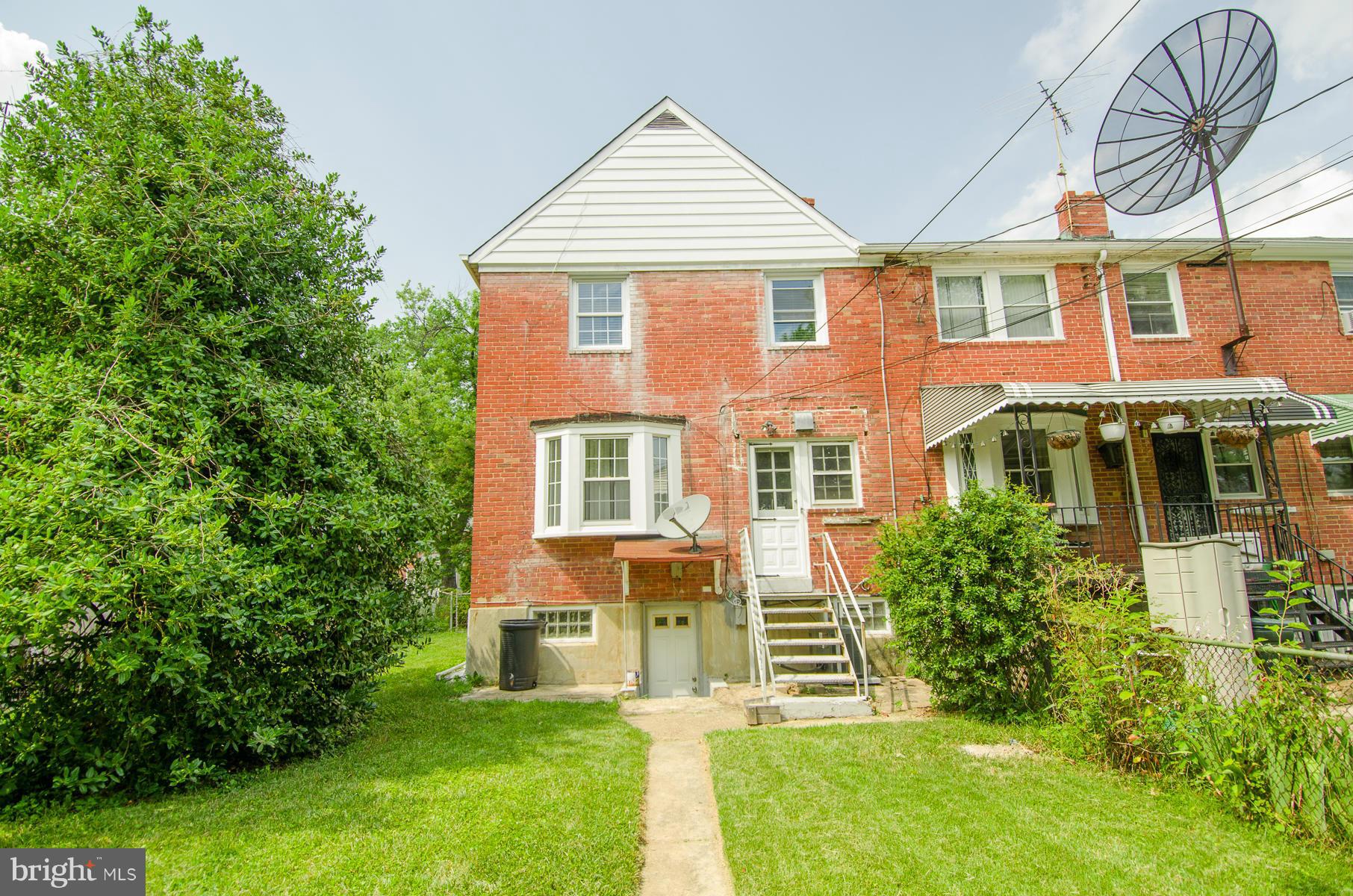 1417 Stonewood Road Baltimore, MD 21239 - Photo 23 of 28 front view of a house with a yard