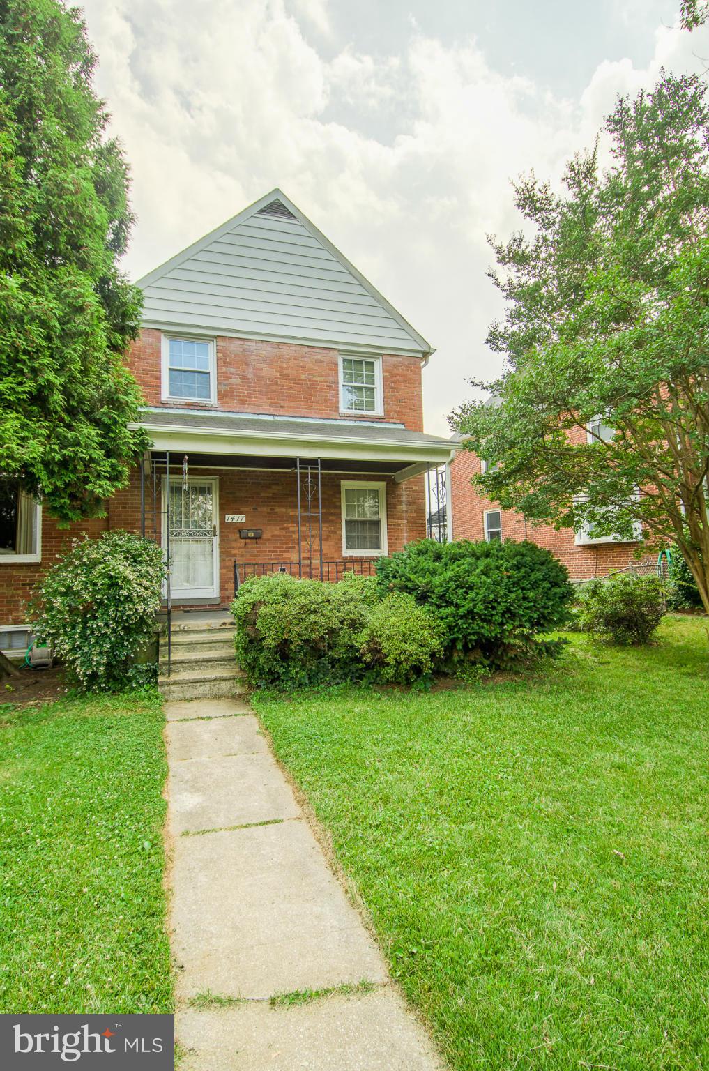 1417 Stonewood Road Baltimore, MD 21239 - Photo 25 of 28 a front view of a house with garden
