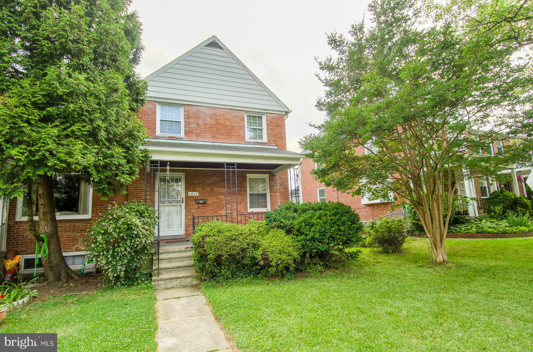 1417 Stonewood Road Baltimore, MD 21239 - Photo 26 of 28 a front view of a house with garden