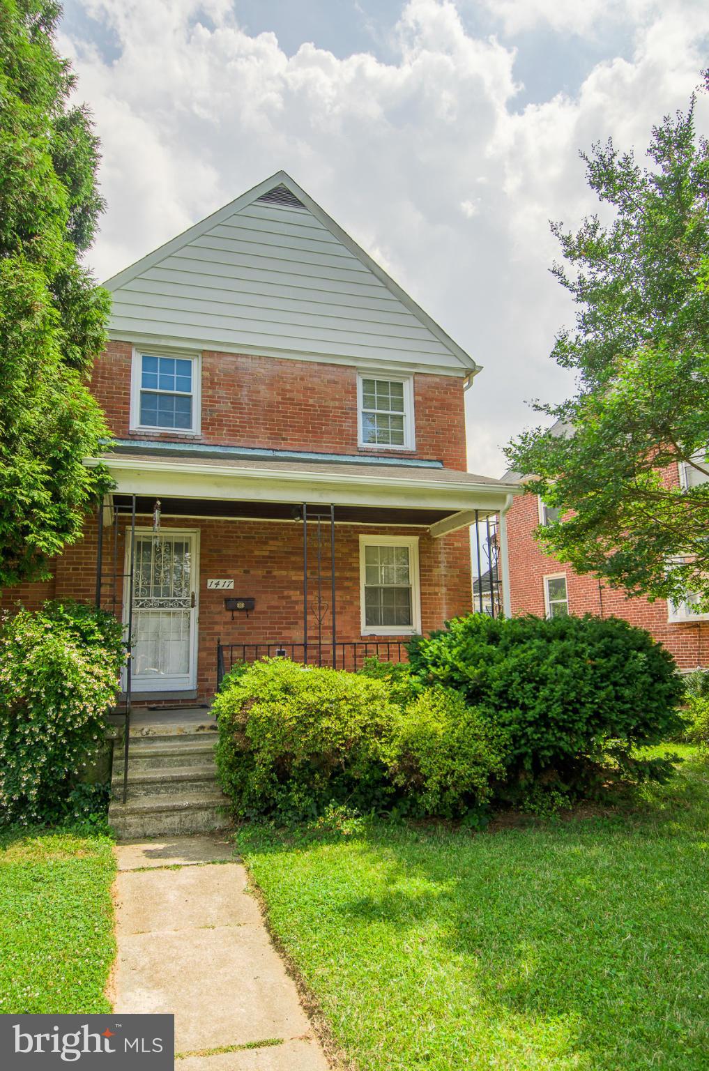 1417 Stonewood Road Baltimore, MD 21239 - Photo 27 of 28 a front view of a house with garden