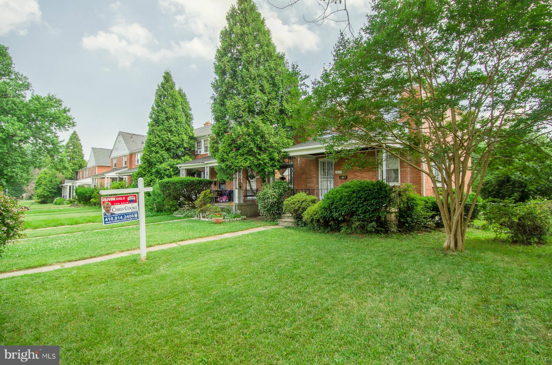 1417 Stonewood Road Baltimore, MD 21239 - Photo 28 of 28 a house with a tree in front of it