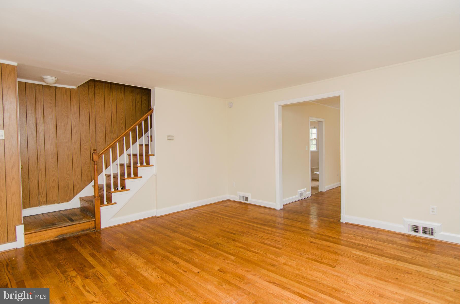 1417 Stonewood Road Baltimore, MD 21239 - Photo 4 of 28 a view of an empty room with wooden floor and stairs