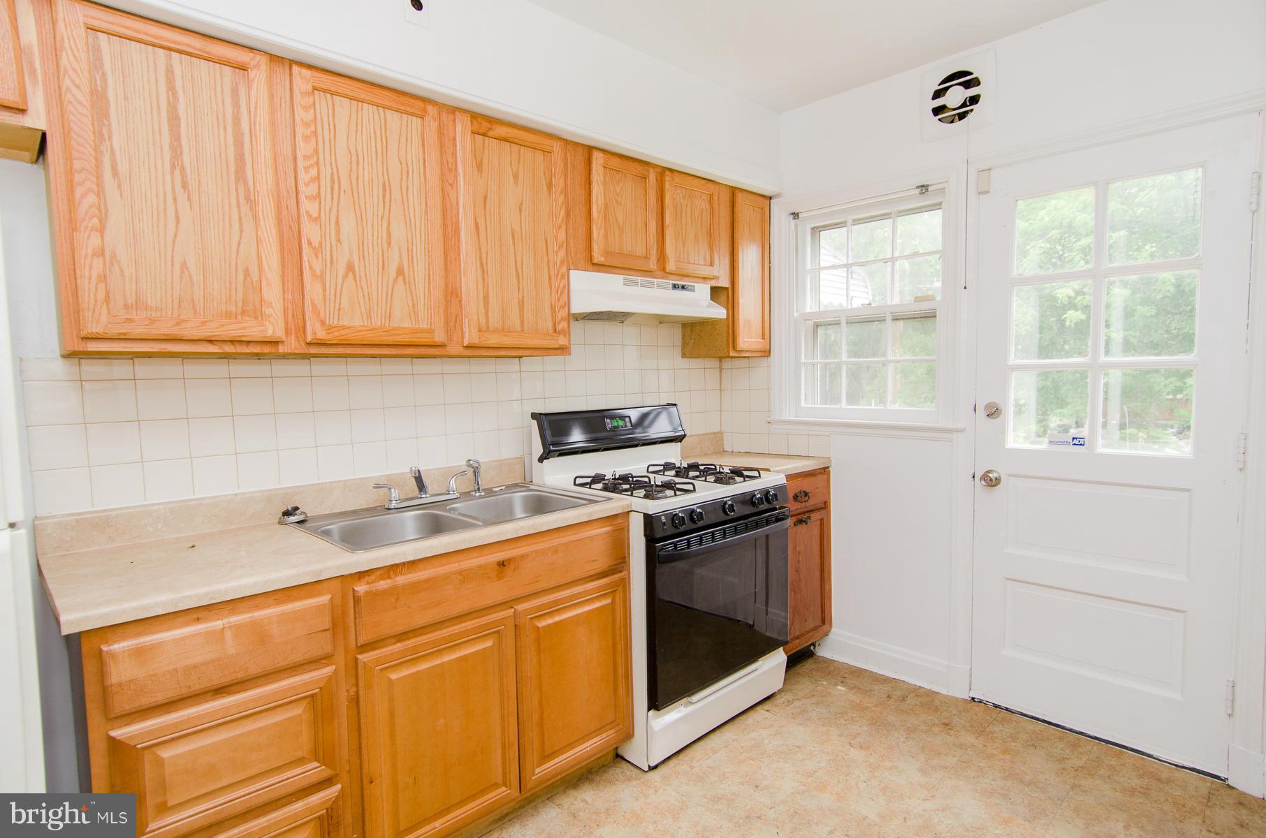 1417 Stonewood Road Baltimore, MD 21239 - Photo 8 of 28 a kitchen with a sink stove and cabinets