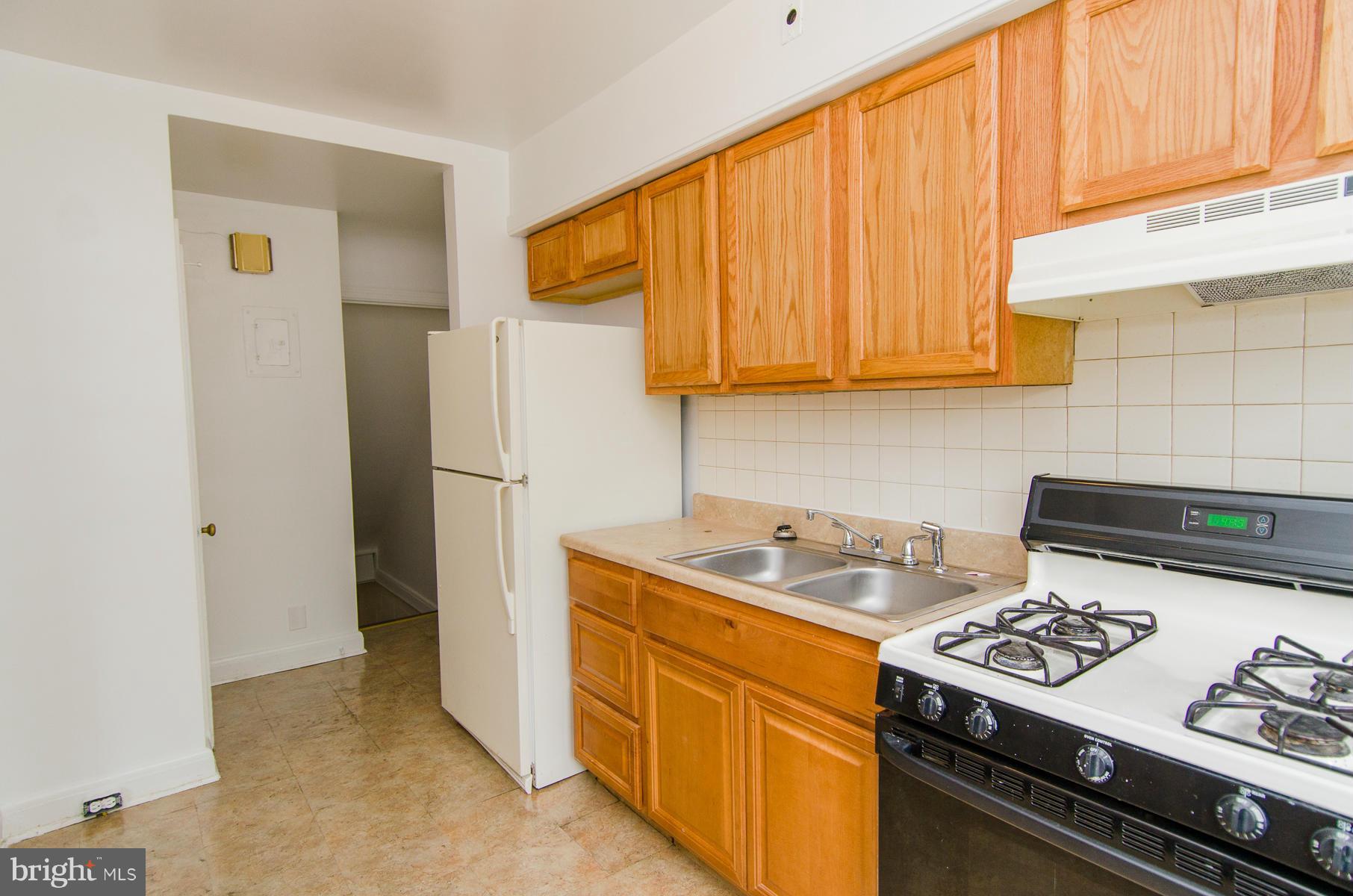 1417 Stonewood Road Baltimore, MD 21239 - Photo 9 of 28 a kitchen with a stove and a refrigerator