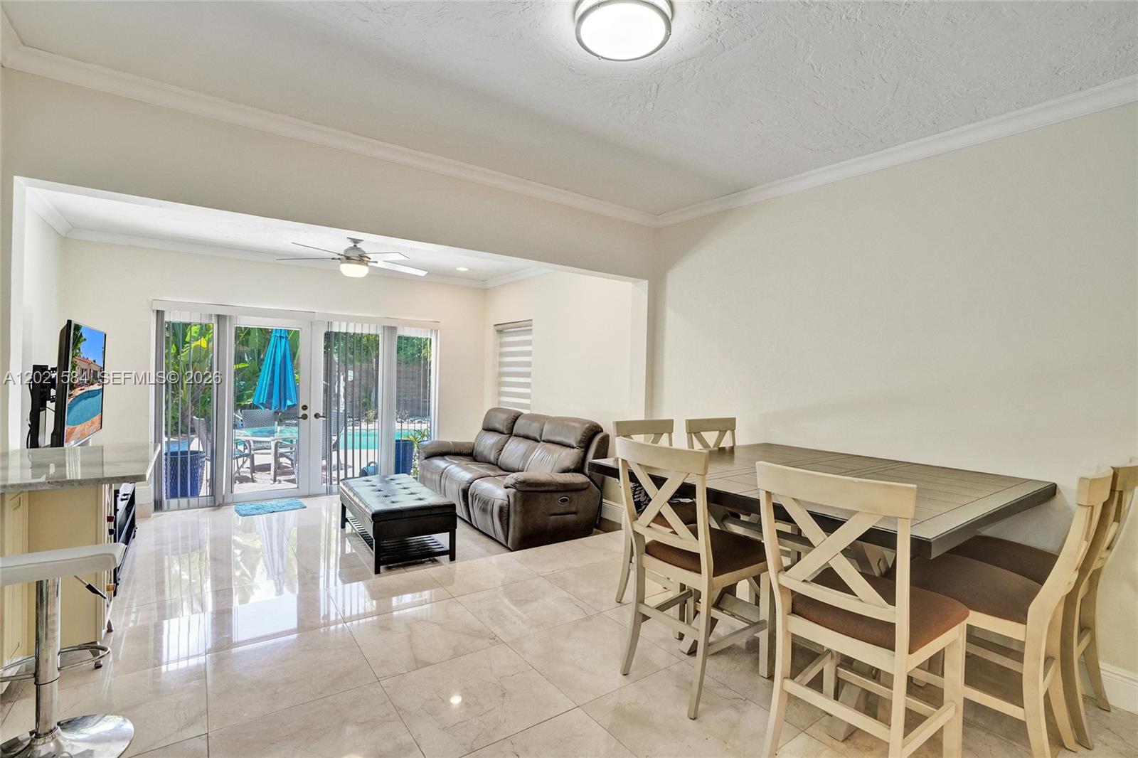 811 Northeast 73rd Street Miami, FL 33138 - Photo 14 of 51 a living room with furniture and a large window