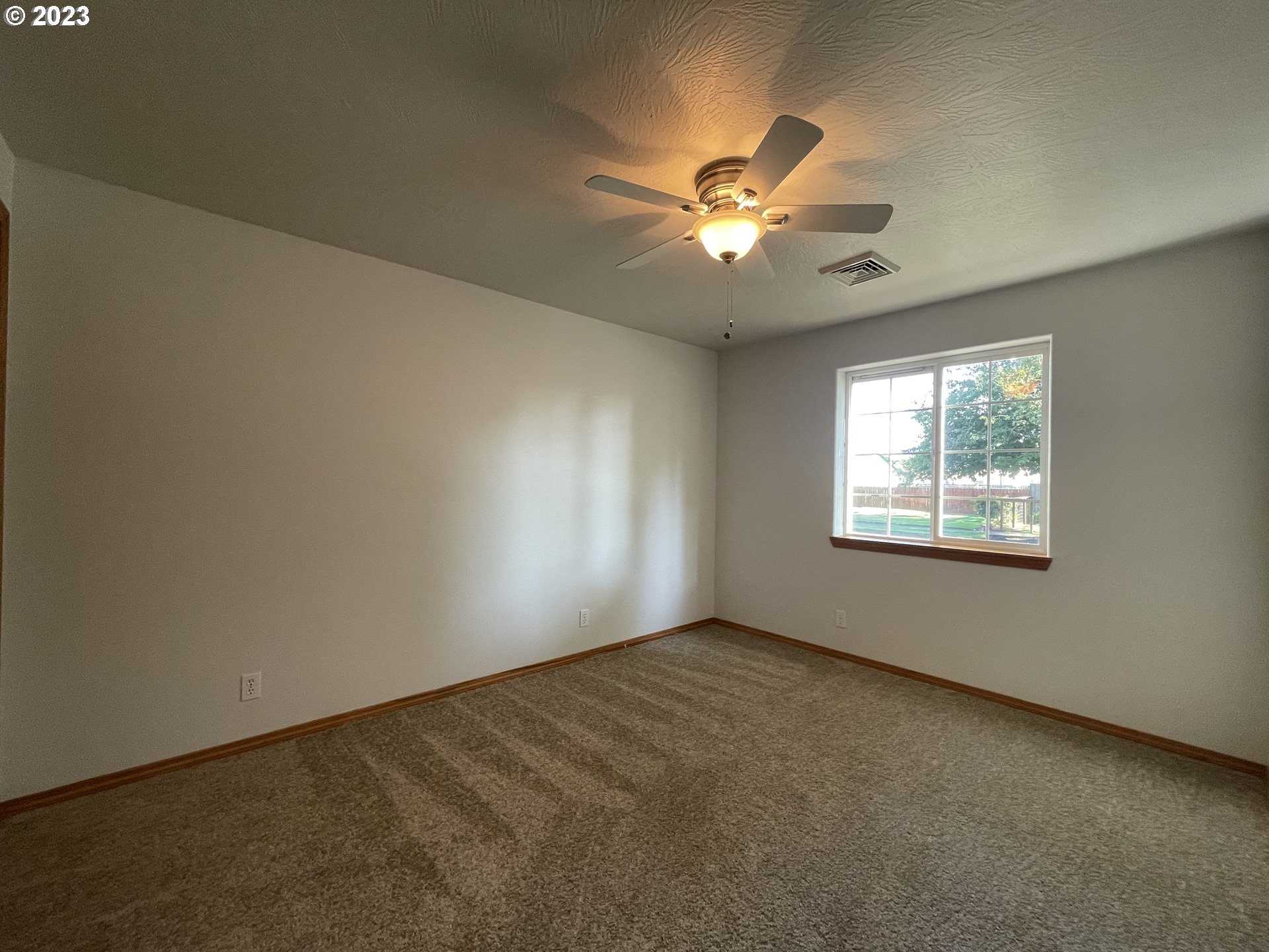 4033 Virginia Avenue Springfield, OR 97478 - Photo 20 of 29 an empty room with a window and a fan