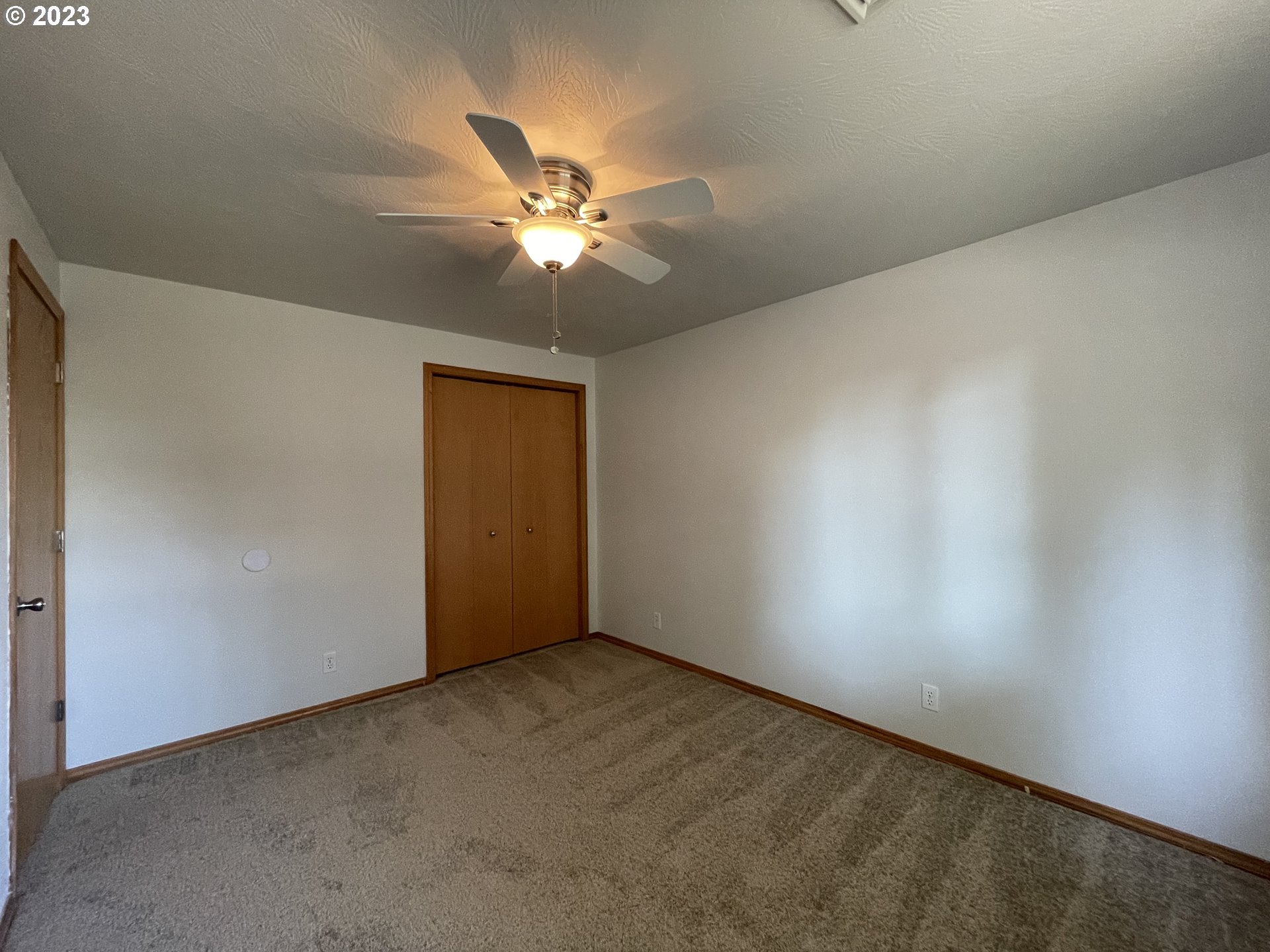 4033 Virginia Avenue Springfield, OR 97478 - Photo 21 of 29 an empty room with a window and a fan