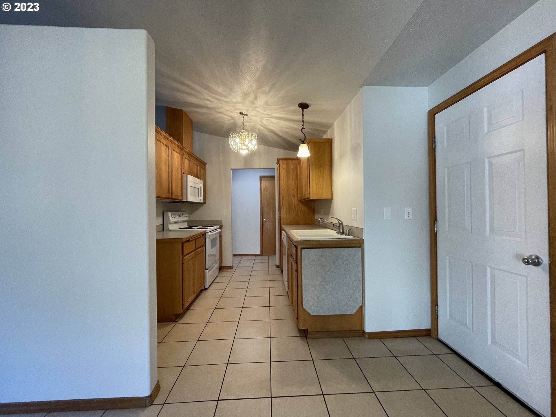 4033 Virginia Avenue Springfield, OR 97478 - Photo 3 of 29 a view of a kitchen with microwave and cabinets