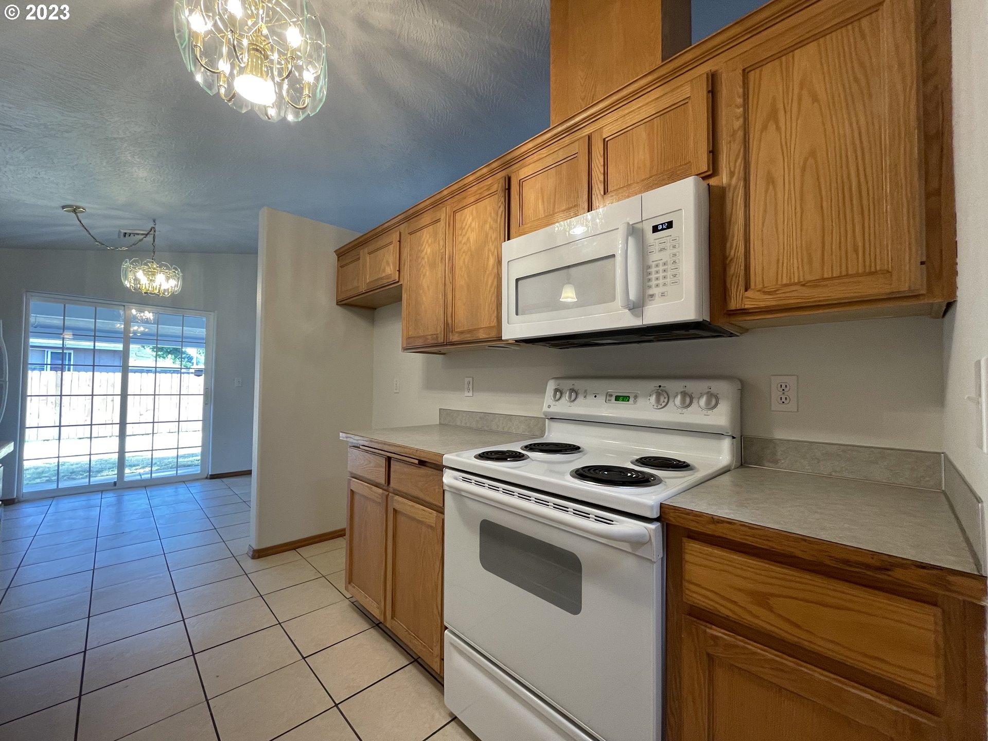 4033 Virginia Avenue Springfield, OR 97478 - Photo 5 of 29 a kitchen with stainless steel appliances granite countertop a stove a sink and a microwave