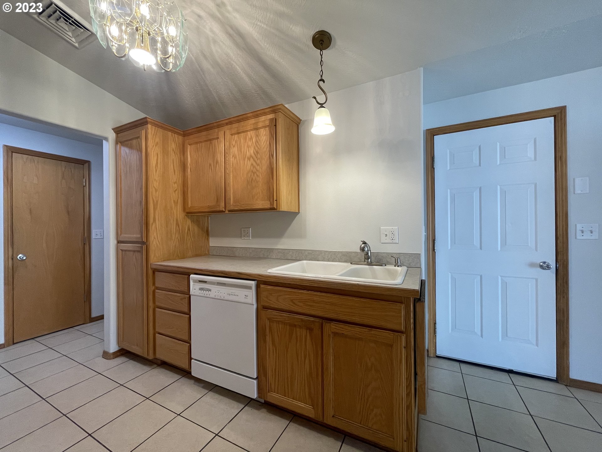4033 Virginia Avenue Springfield, OR 97478 - Photo 6 of 29 a kitchen with cabinets and chandelier