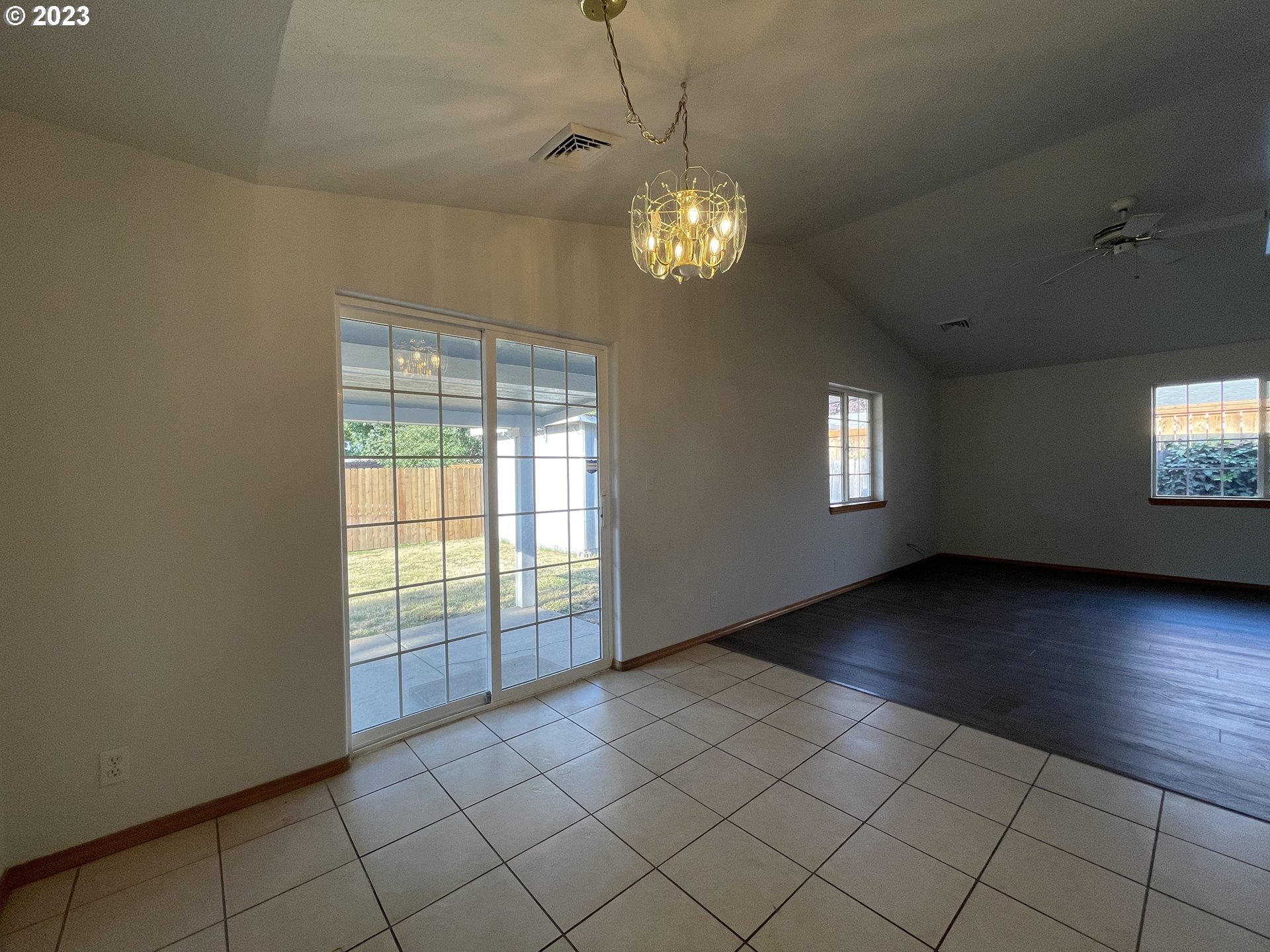 4033 Virginia Avenue Springfield, OR 97478 - Photo 7 of 29 an empty room with wooden floor fan and windows