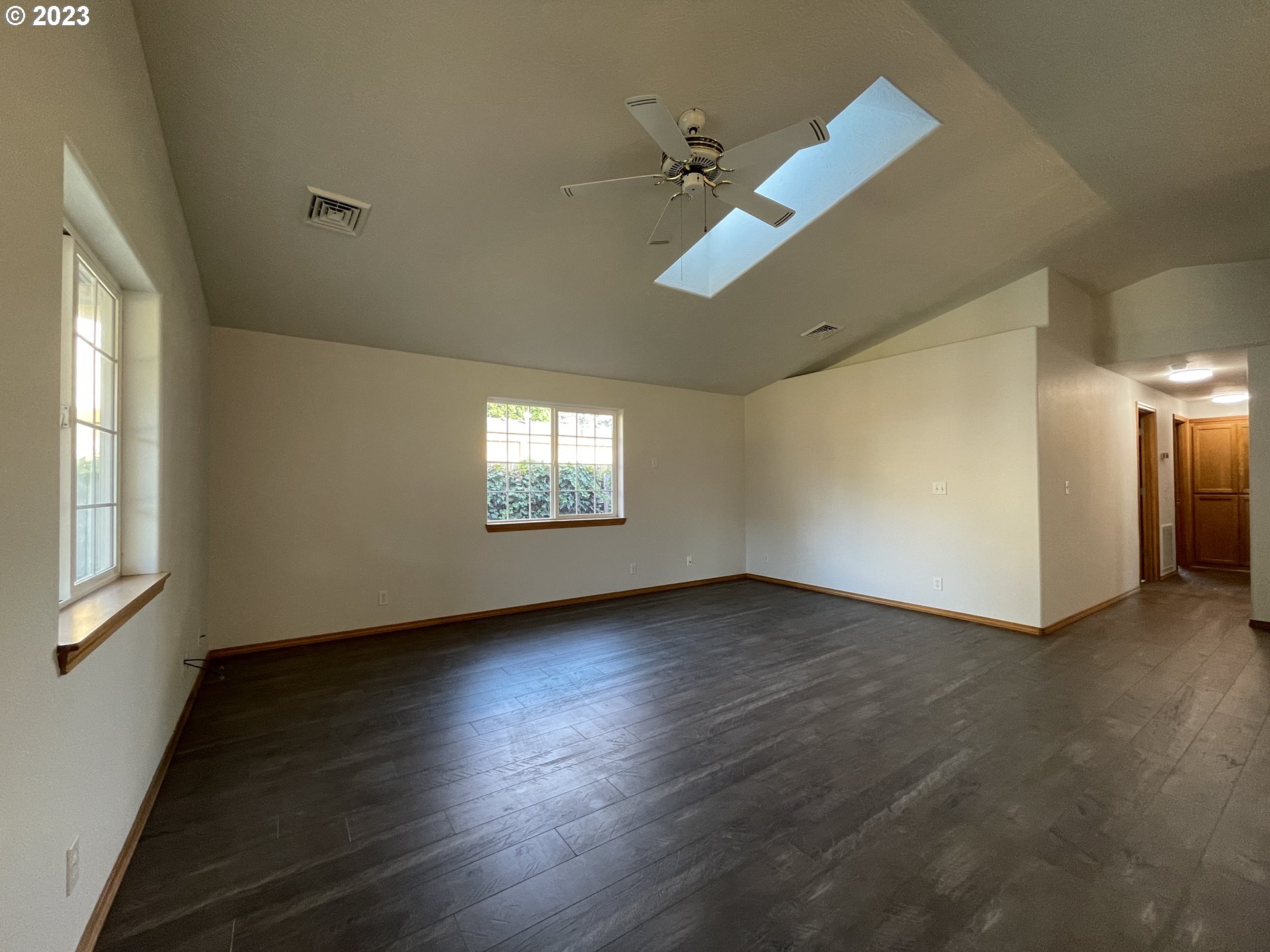 4033 Virginia Avenue Springfield, OR 97478 - Photo 9 of 29 an empty room with wooden floor fan and windows