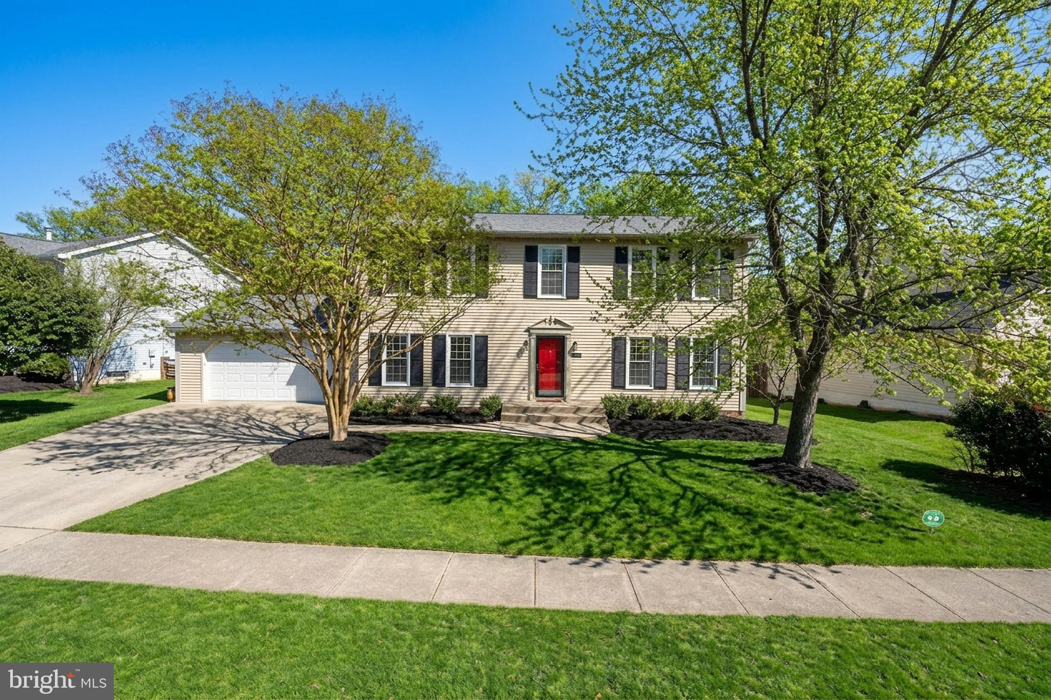 21112 Midday Lane Sterling, VA 20164 - Photo 1 of 1 a front view of a house with a garden