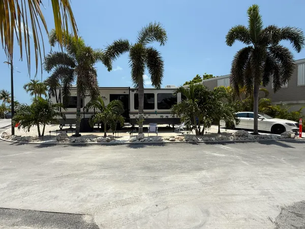 a view of a house with swimming pool and sitting area