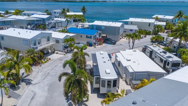 an aerial view of a houses with yard