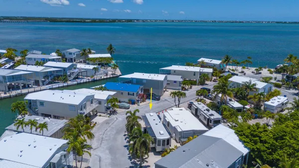 an aerial view of a house with a lake view