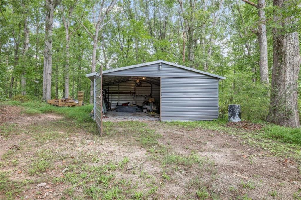 131 Caudell Drive Lula, GA 30554 - Photo 52 of 58 a backyard of a house with a large tree and wooden fence