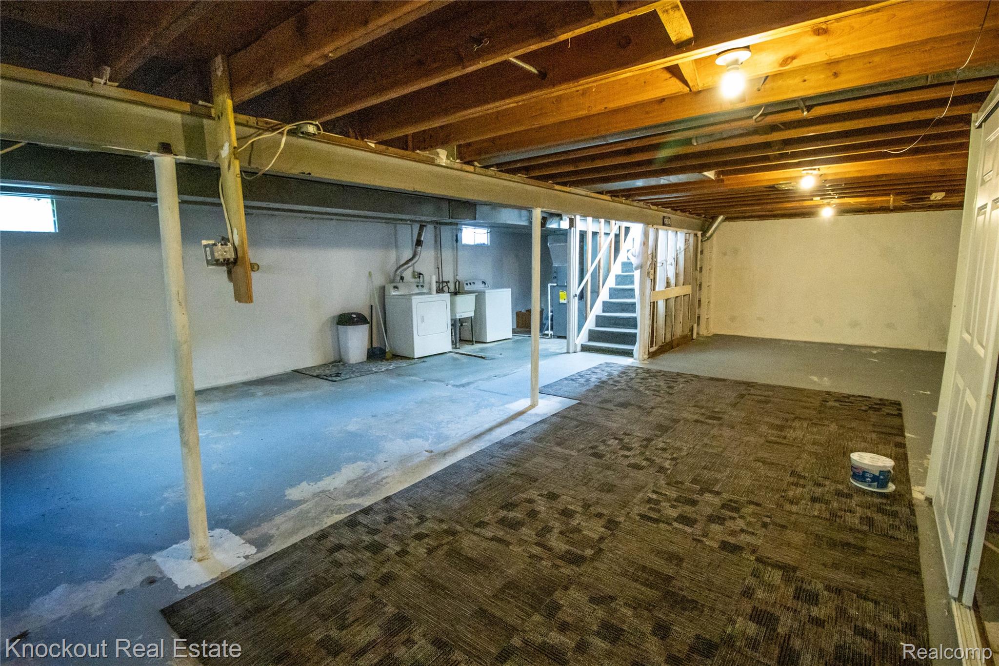 5796 East Burt Road Birch Run, MI 48415 - Photo 28 of 41 Unfinished basement with exposed ceiling joists, concrete flooring, and an integrated laundry area