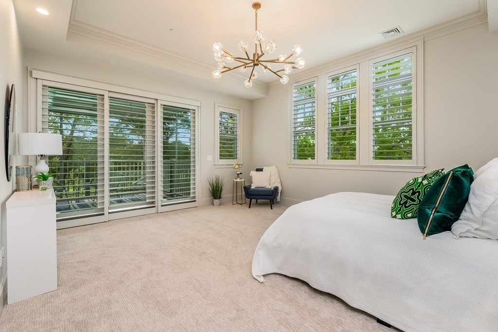 64 Simons Road, Unit F Mashpee, MA 02649 - Photo 11 of 33 a spacious bedroom with a bed and large windows