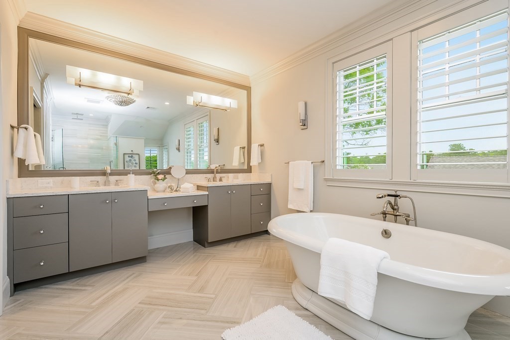64 Simons Road, Unit F Mashpee, MA 02649 - Photo 15 of 33 a bathroom with a sink a toilet and a large mirror
