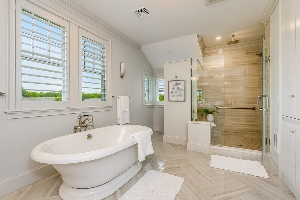 64 Simons Road, Unit F Mashpee, MA 02649 - Photo 16 of 33 a bathroom with a bathtub and a shower