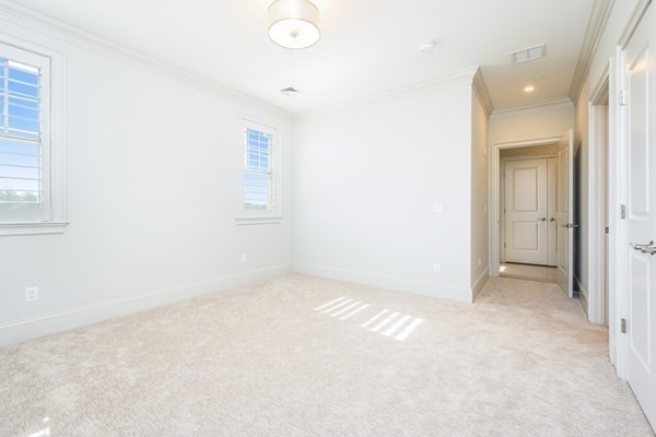 64 Simons Road, Unit F Mashpee, MA 02649 - Photo 20 of 33 an empty room with windows and closet